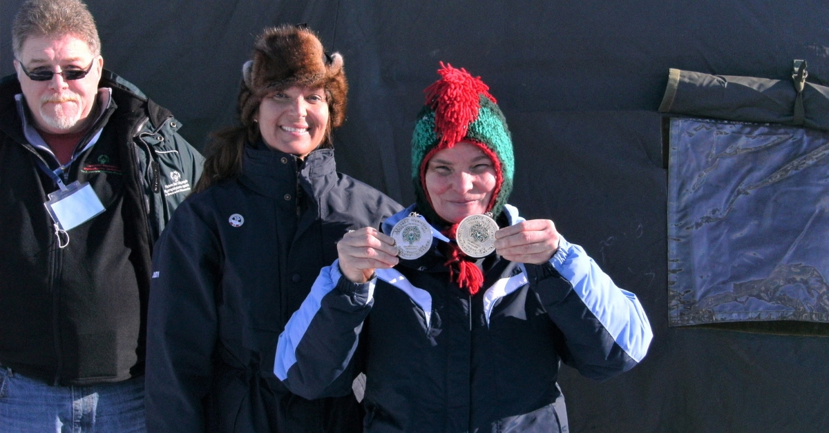 Patti Connors holds two medals at a Winter Games.