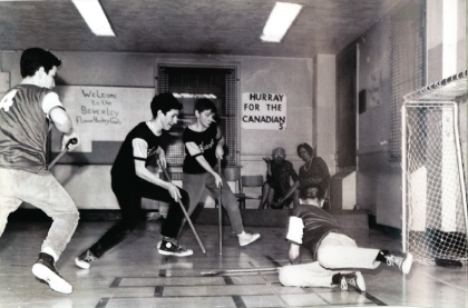 Floor hockey players compete in the basement of the Beverley School