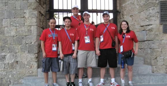 Gord Stewart poses with athletes while seeing the sights at the World Games in Greece.