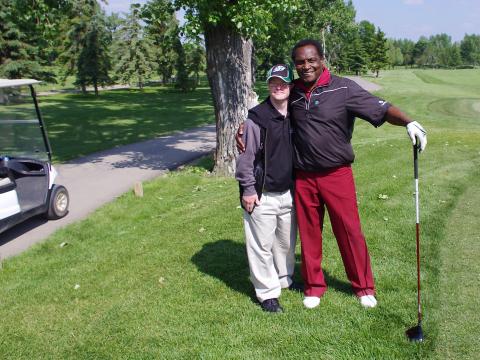 George Reed with a local athlete at the George Reed Golf Tournament for Special Olympics in Regina.