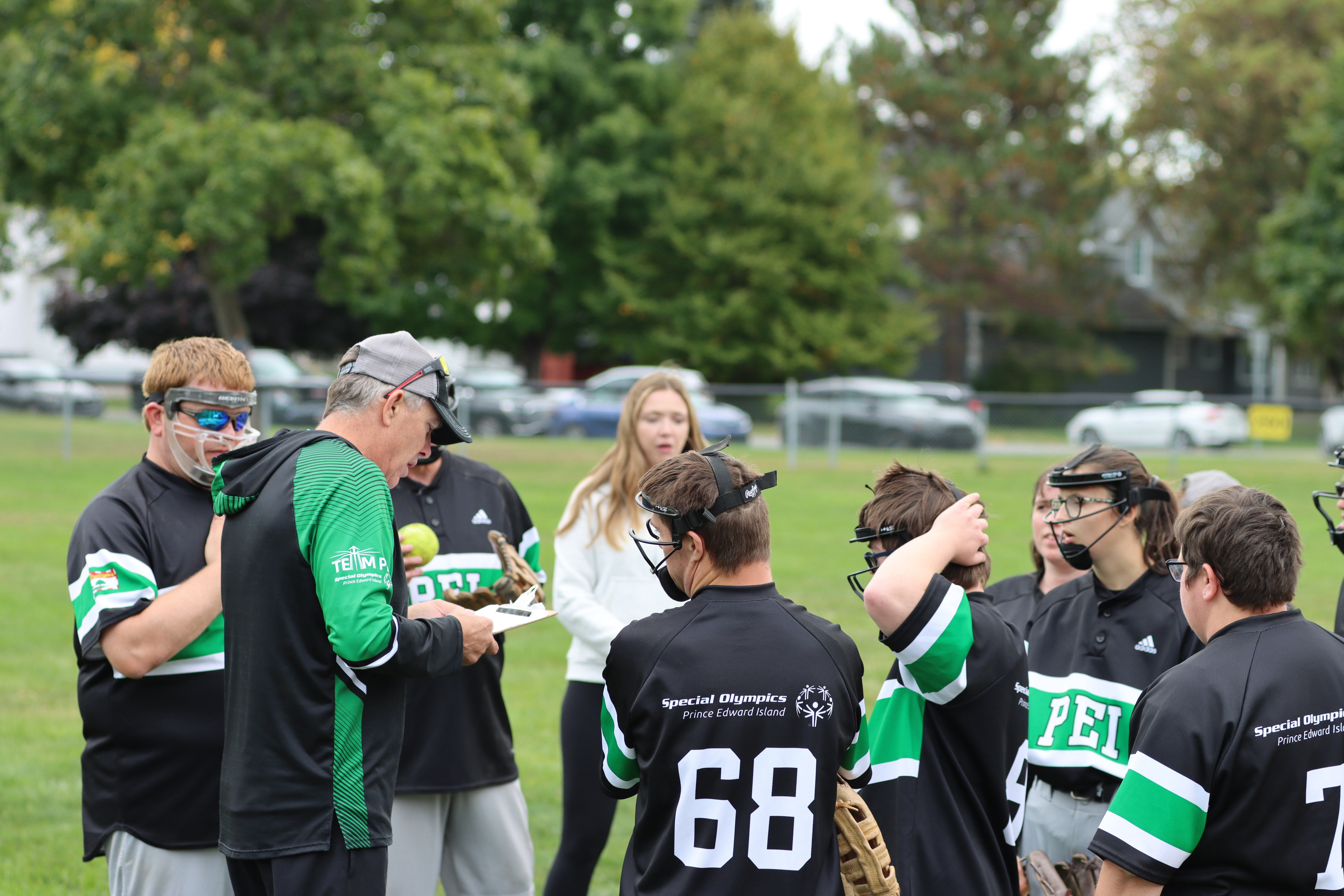 Team PEI Softball competing at the 2024 SONB Invitational, Special Olympics PEI, Softball, Coach with Group of Athletes Team PEI Softball competing at the 2024 SONB Invitational, Special Olympics PEI, Softball, Coach with Group of Athletes