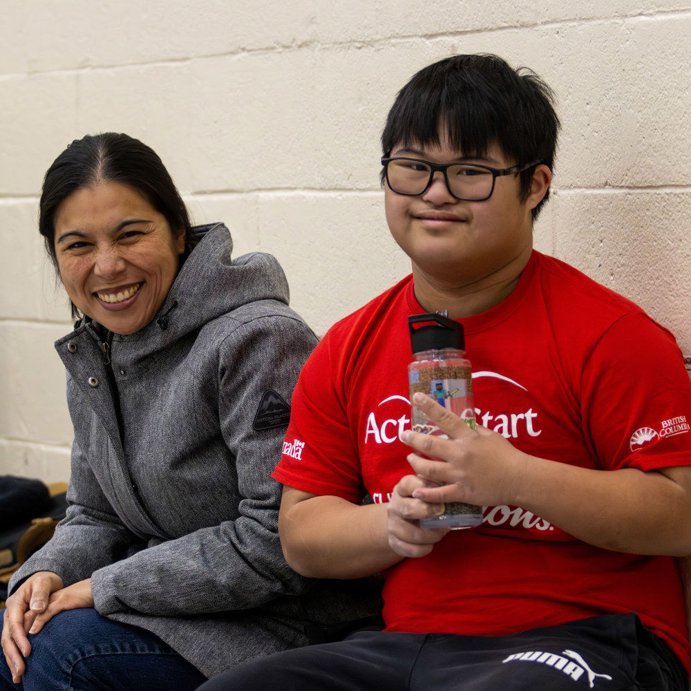 Specical Olympics BC athlete Marcus poses together with his mom.