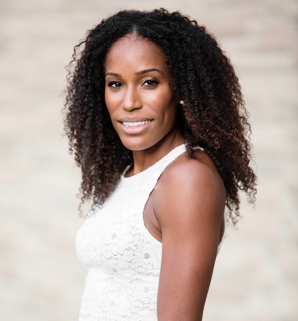 Headshot of a women with black very curly hair in a white dress. Headshot of a women with black very curly hair in a white dress.