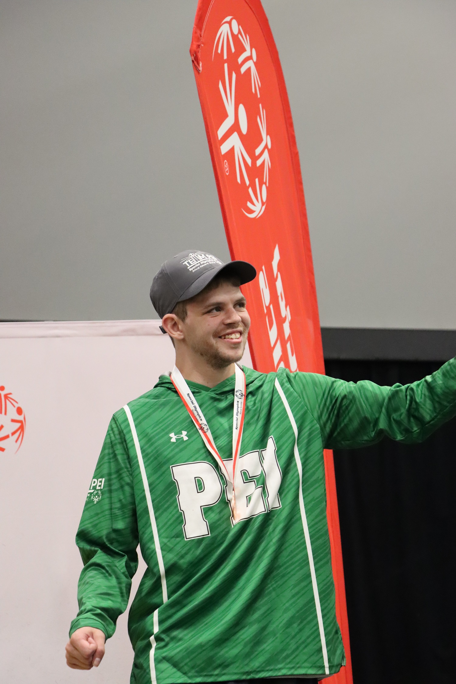 Team PEI 2026 Swimming athlete, Matthew Gallant, standing on a podium with a medal