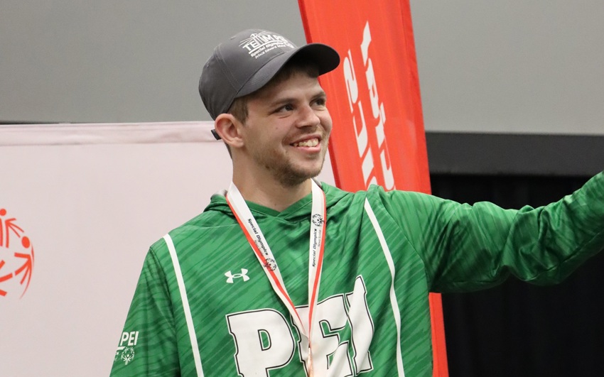 Team PEI 2026 Swimming athlete, Matthew Gallant, standing on a podium with a medal