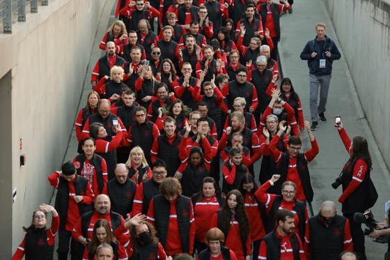 Un grand groupe de personnes marchant. Tous vêtus de vêtements rouges du Canada. 