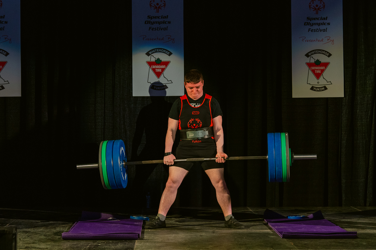 Brandle competing in powerlifting at a Special Olympics event.