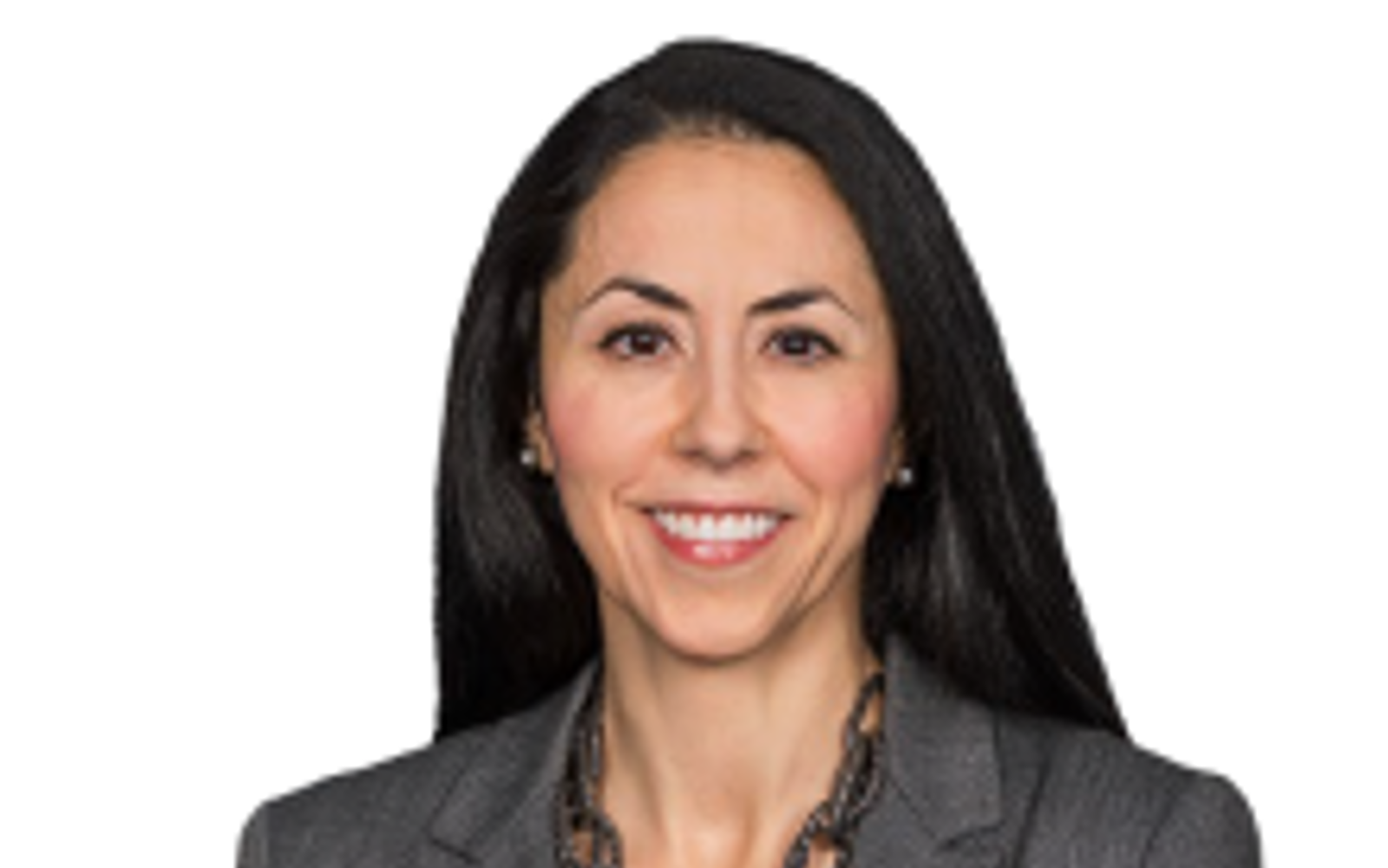 Woman with dark hair wearing a grey blazer. 