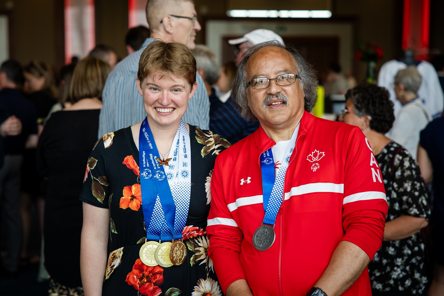 Two Special Olympics athletes standing while wearing medals at the Enriching Lives Gala