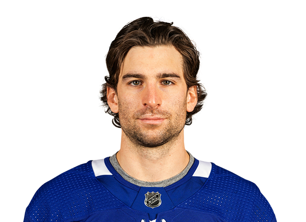 Headshot of a man in a blue hockey jersey Headshot of a man in a blue hockey jersey