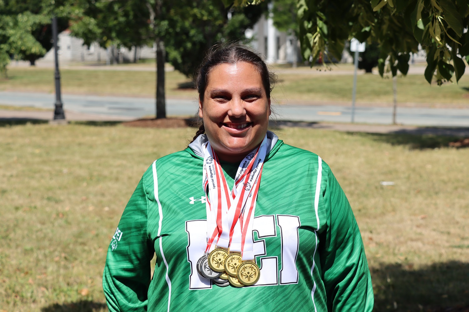 Team PEI 2026 Swimming athlete, Sarah Halman, standing outside, wearing her medals