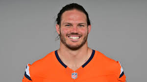 Headshot a man in an orange NHL jersey Headshot a man in an orange NHL jersey
