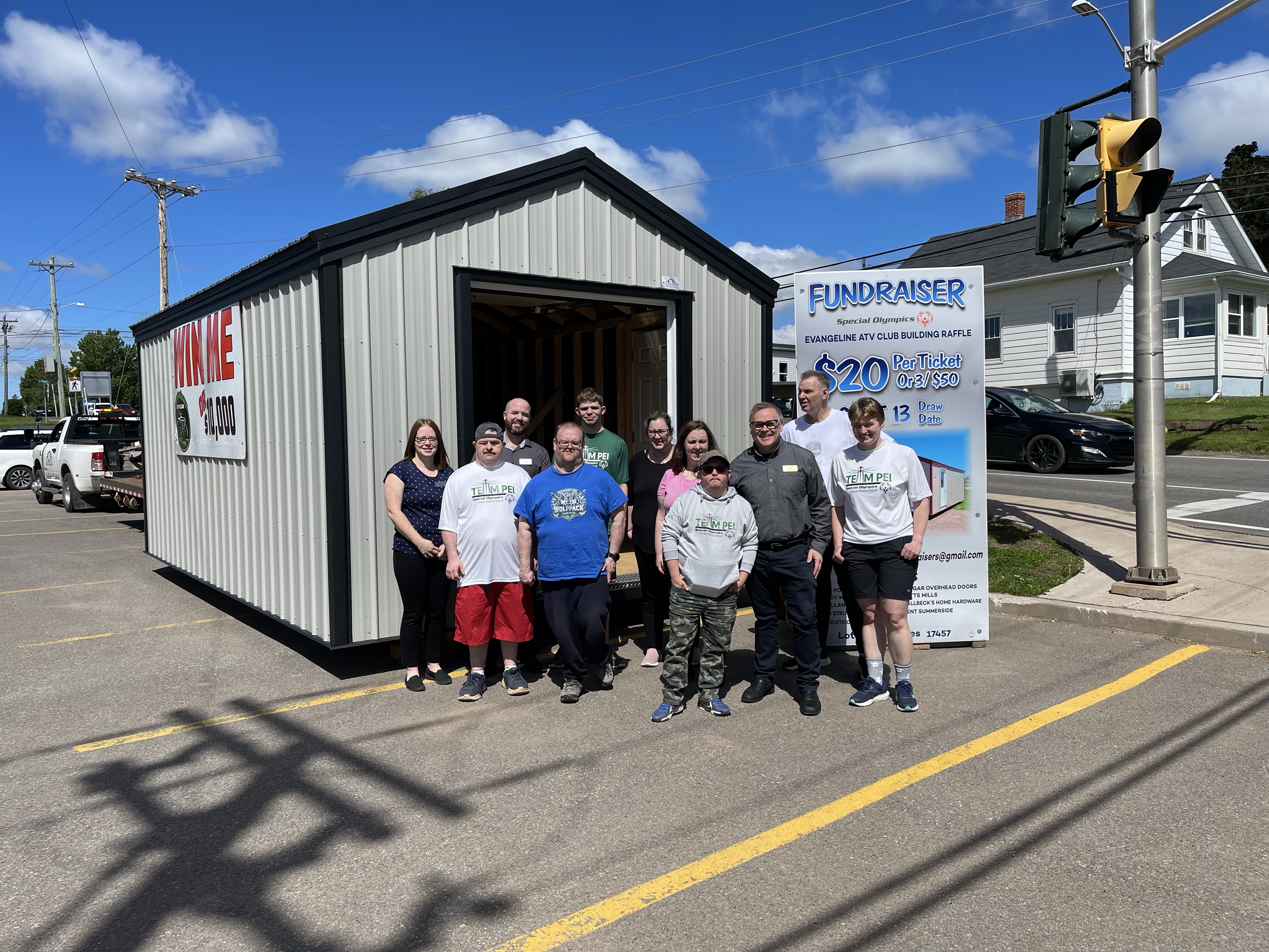 A group of athletes and Sobeys staff standing in from of a Shed