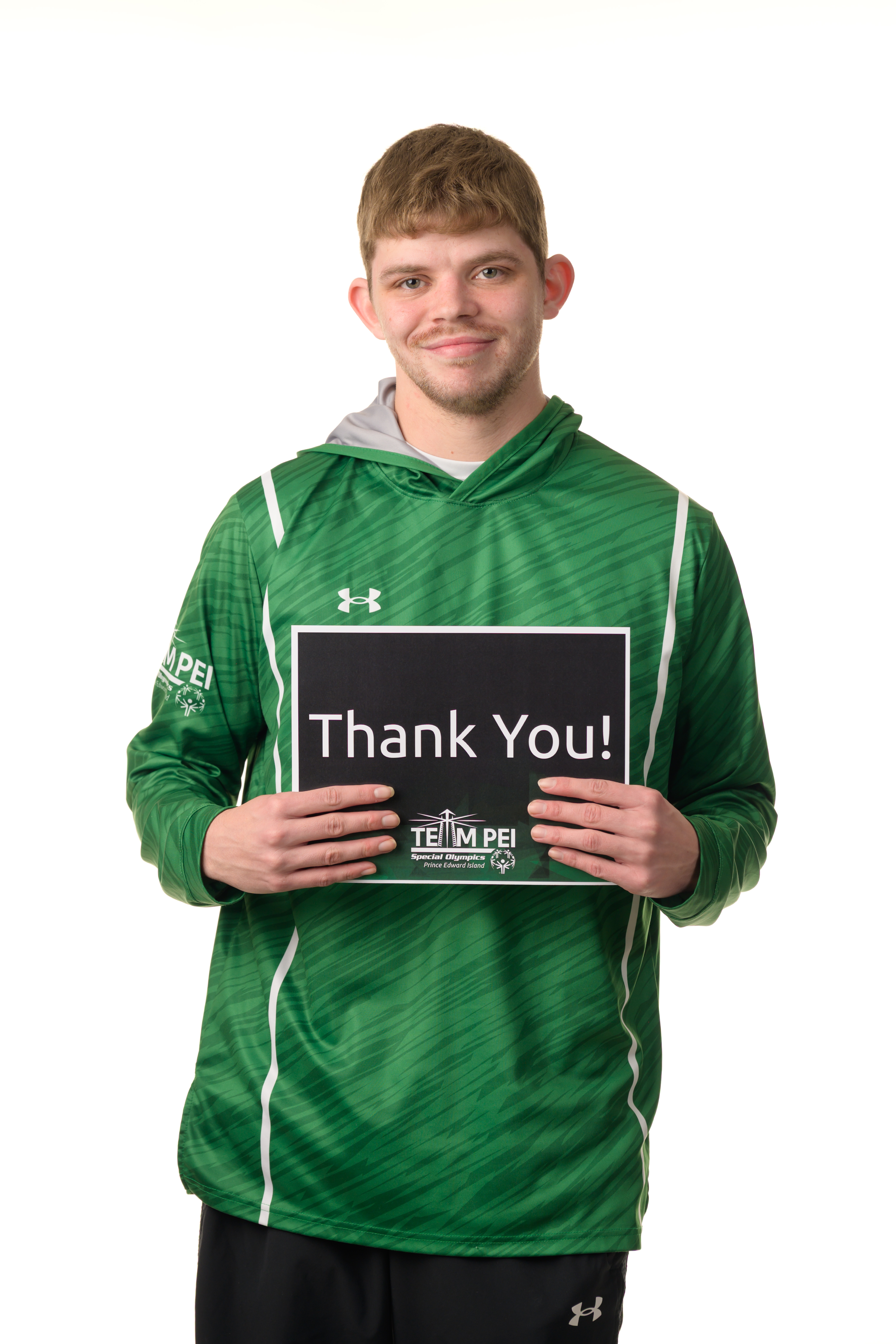 Team PEI 2026 Swimming athlete, Matthew Gallant, standing with a thank you sign