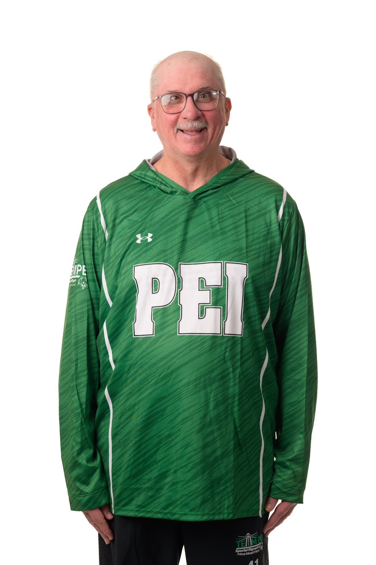 A headshot photo of Tommy MacGuigan wearing his green PEI hoodie.