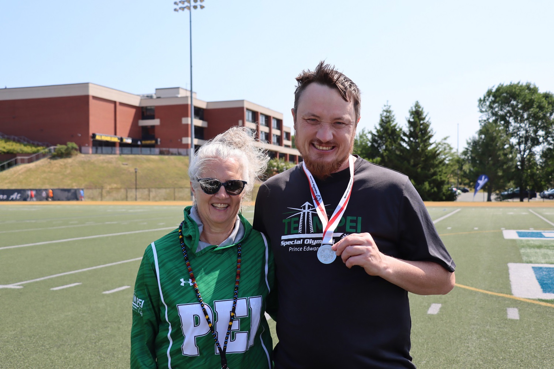 Special Olympics PEI, Athlete with Volunteer, Athletics, Athlete with Medal