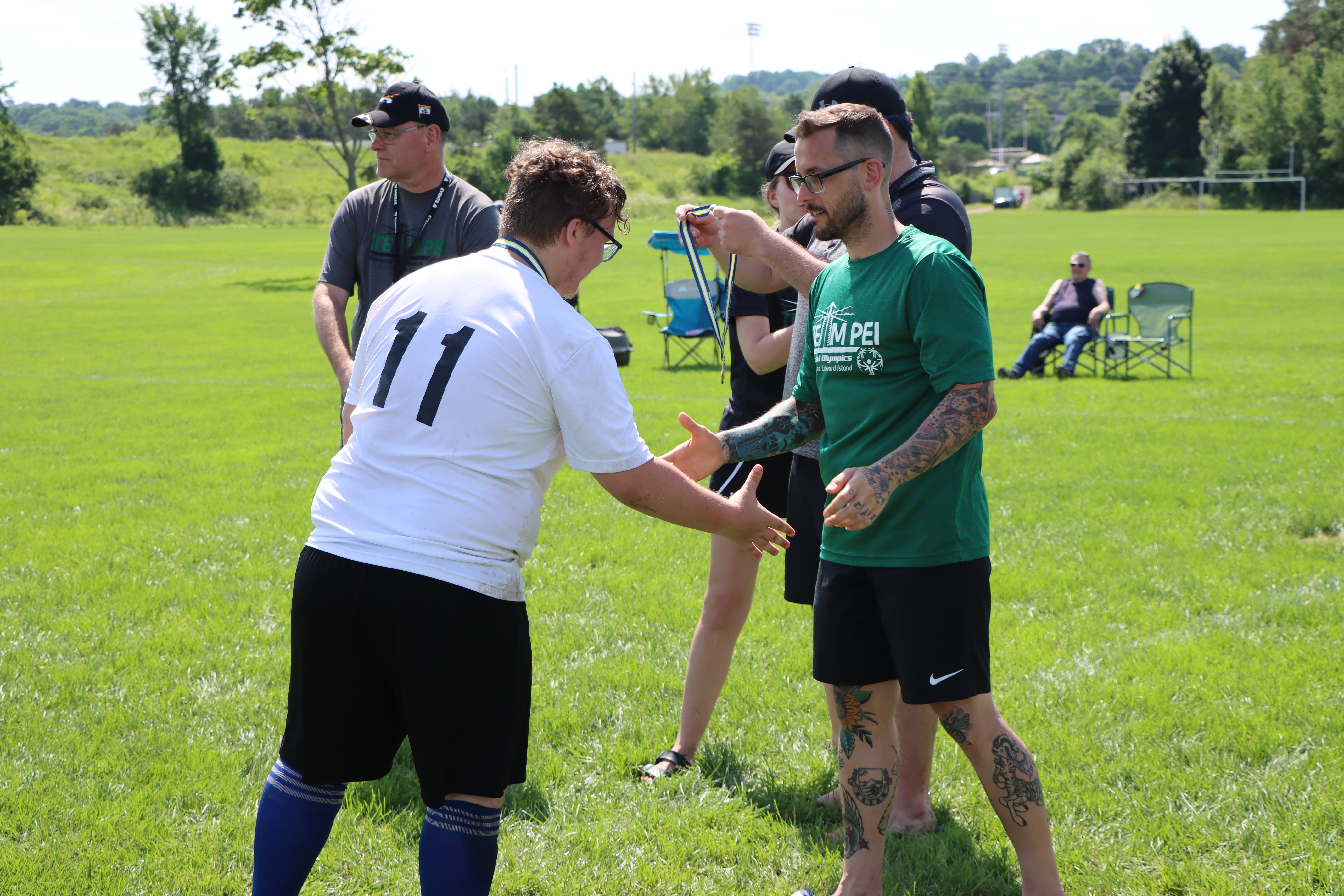 Soccer coach shaking hands with an athlete following a game