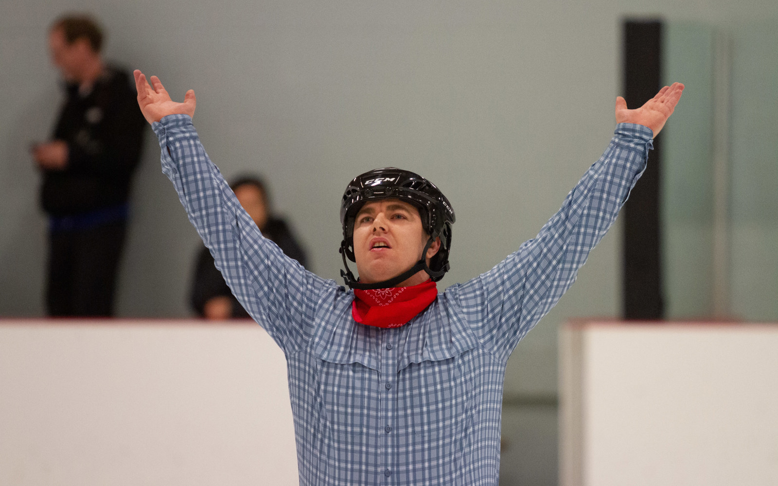 Special Olympics BC - Port Alberni athlete poses with his hands above his head at the end of his figure skating performance.