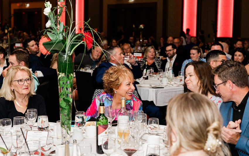 Long time Special Olympics PEI Enriching Lives Gala Committee volunteer, Betty Anne Morrison at a dinner table with other guests