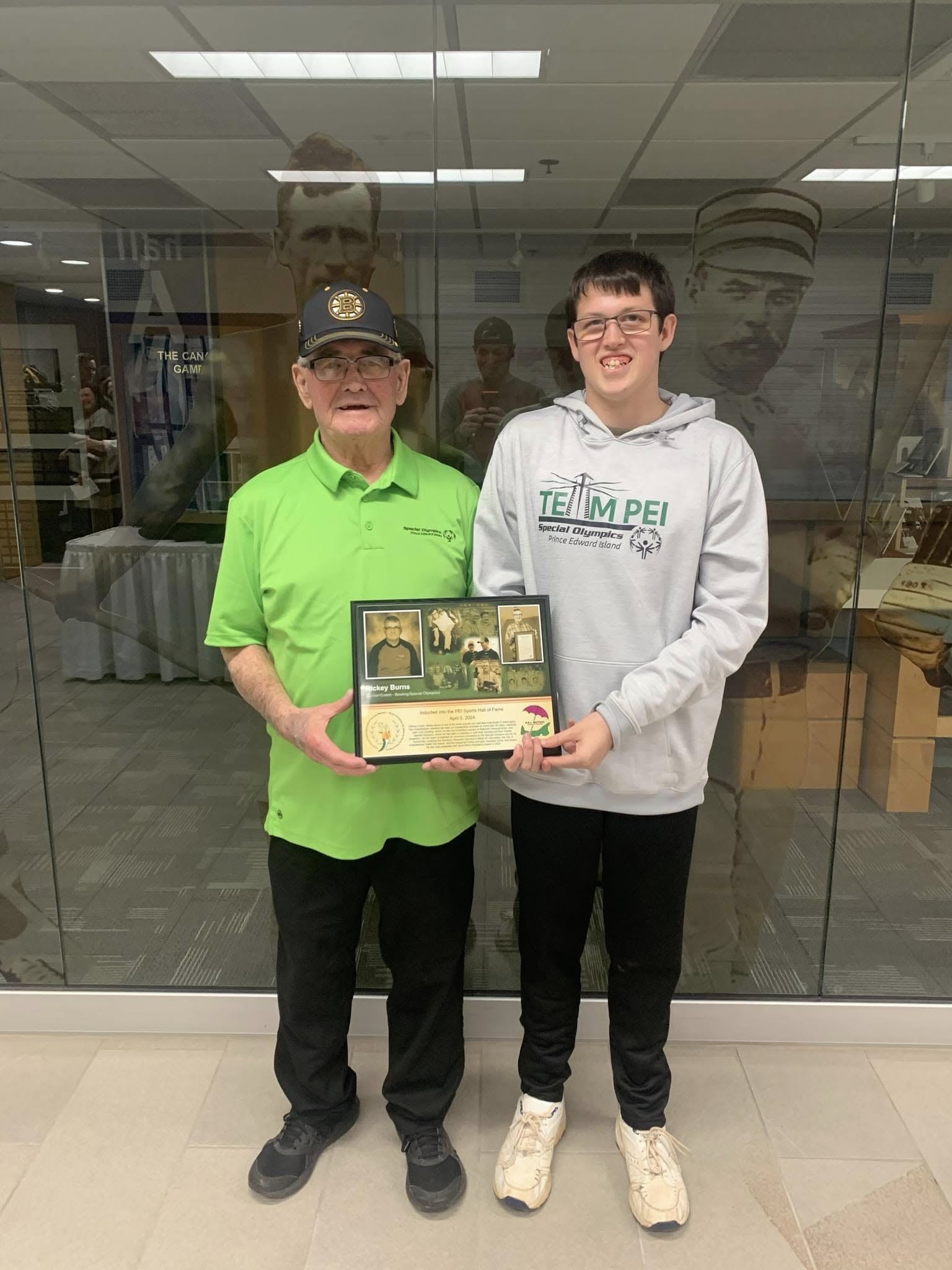 Rickey Burns following his induction in the PEI Sports Hall of Fame, standing with his grandson