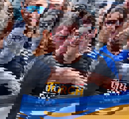 A close of Special Olympics BC athlete Reid Demelo as he runs with the Port Moody Police Department for the 2024 Law Enforcement Torch Run Torch Run event.