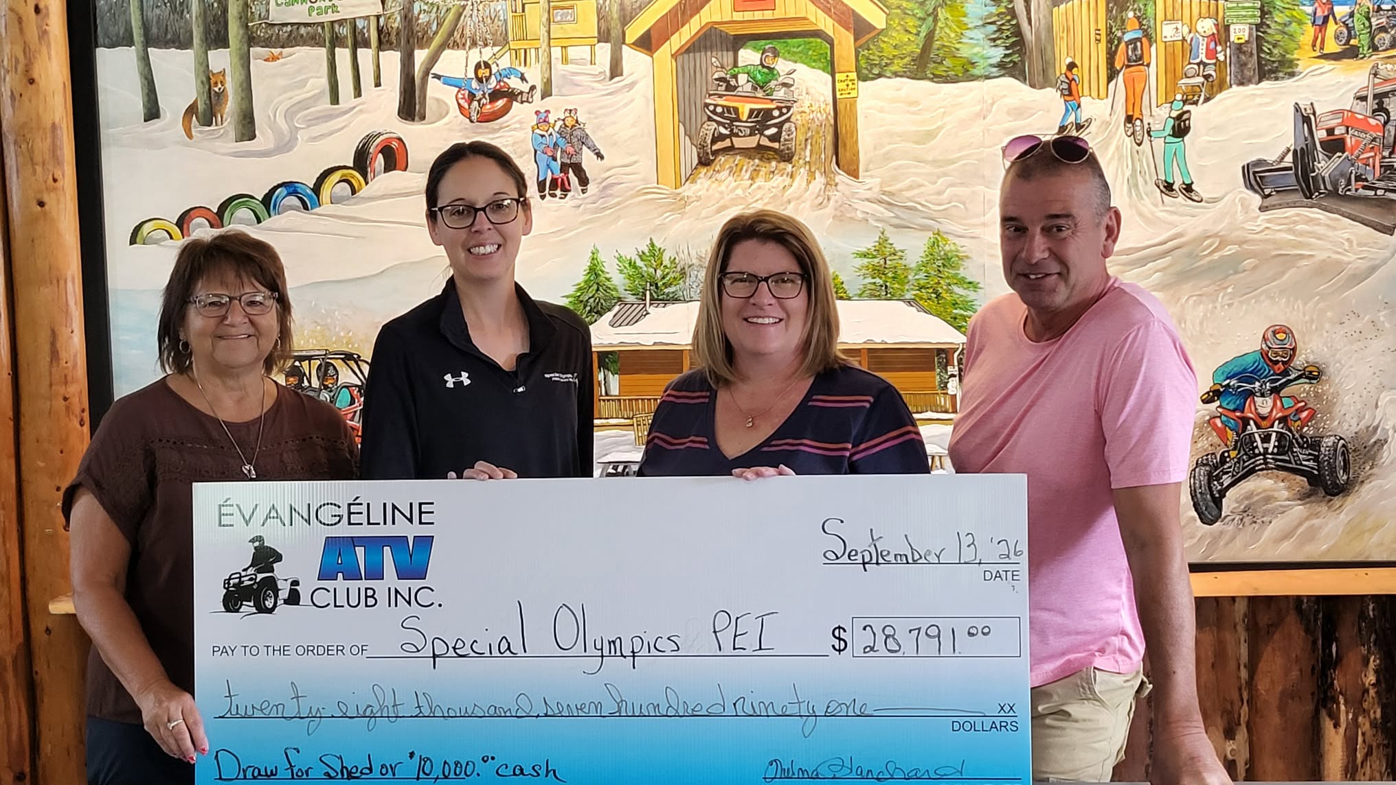 Special Olympics PEI accepts a cheque from the Evangeline ATV Club following the Shed Raffle fundraiser Special Olympics PEI accepts a cheque from the Evangeline ATV Club following the Shed Raffle fundraiser