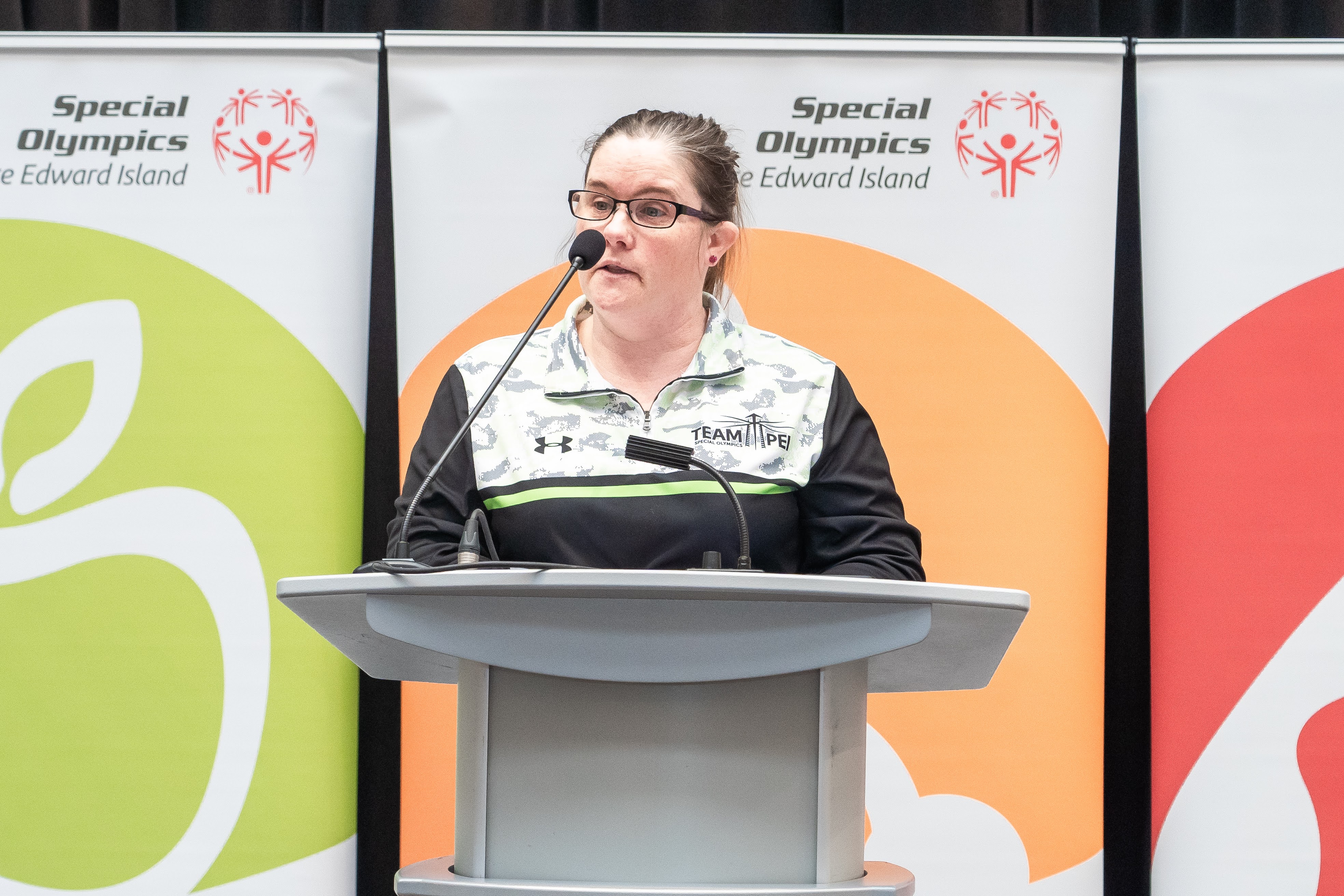 Athlete Leader, Erin Pippy, speaking at a podium