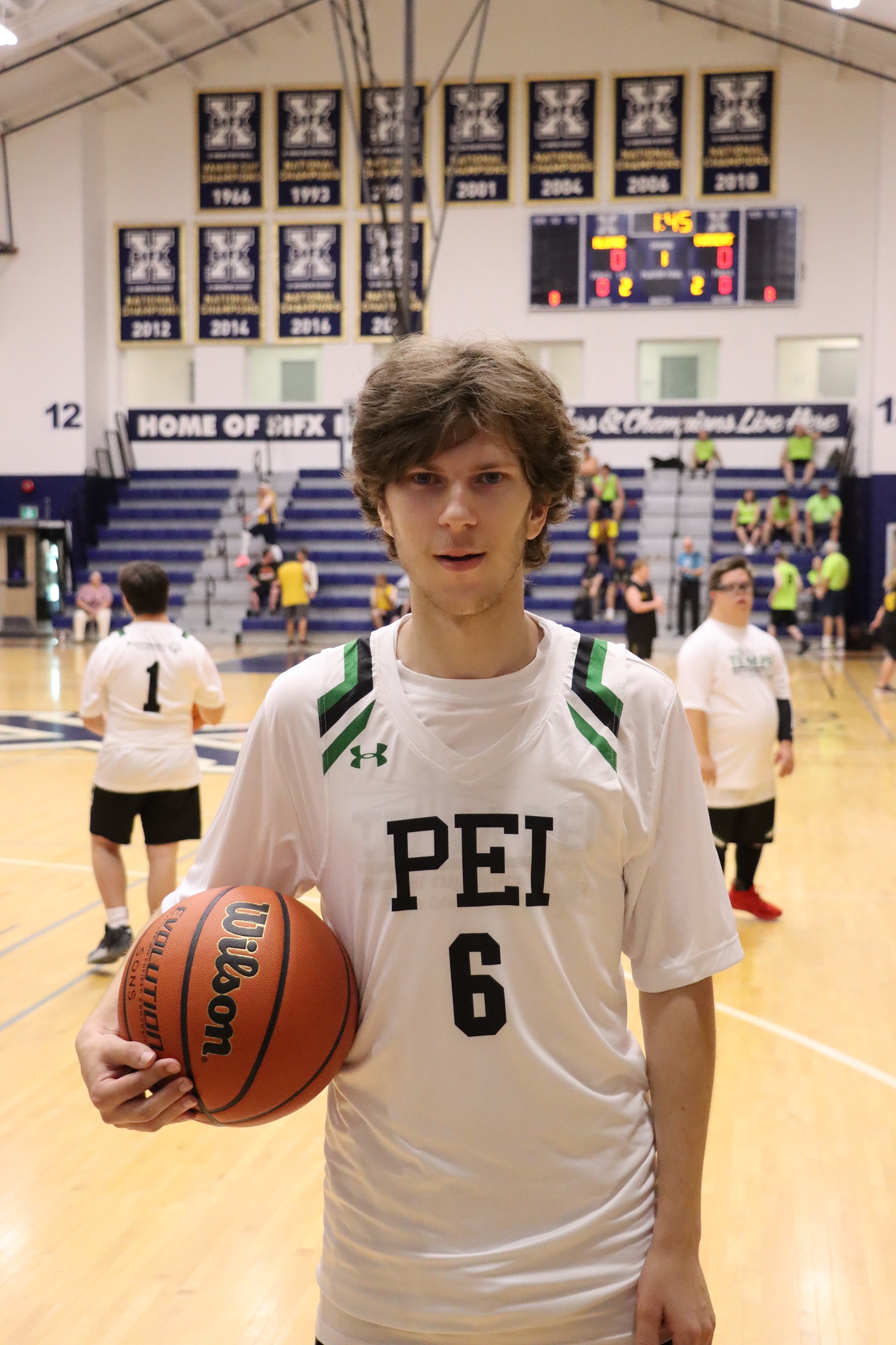 Team PEI 2026 Basketball athlete, Zachary Hebert, stands on the court holding a basketball
