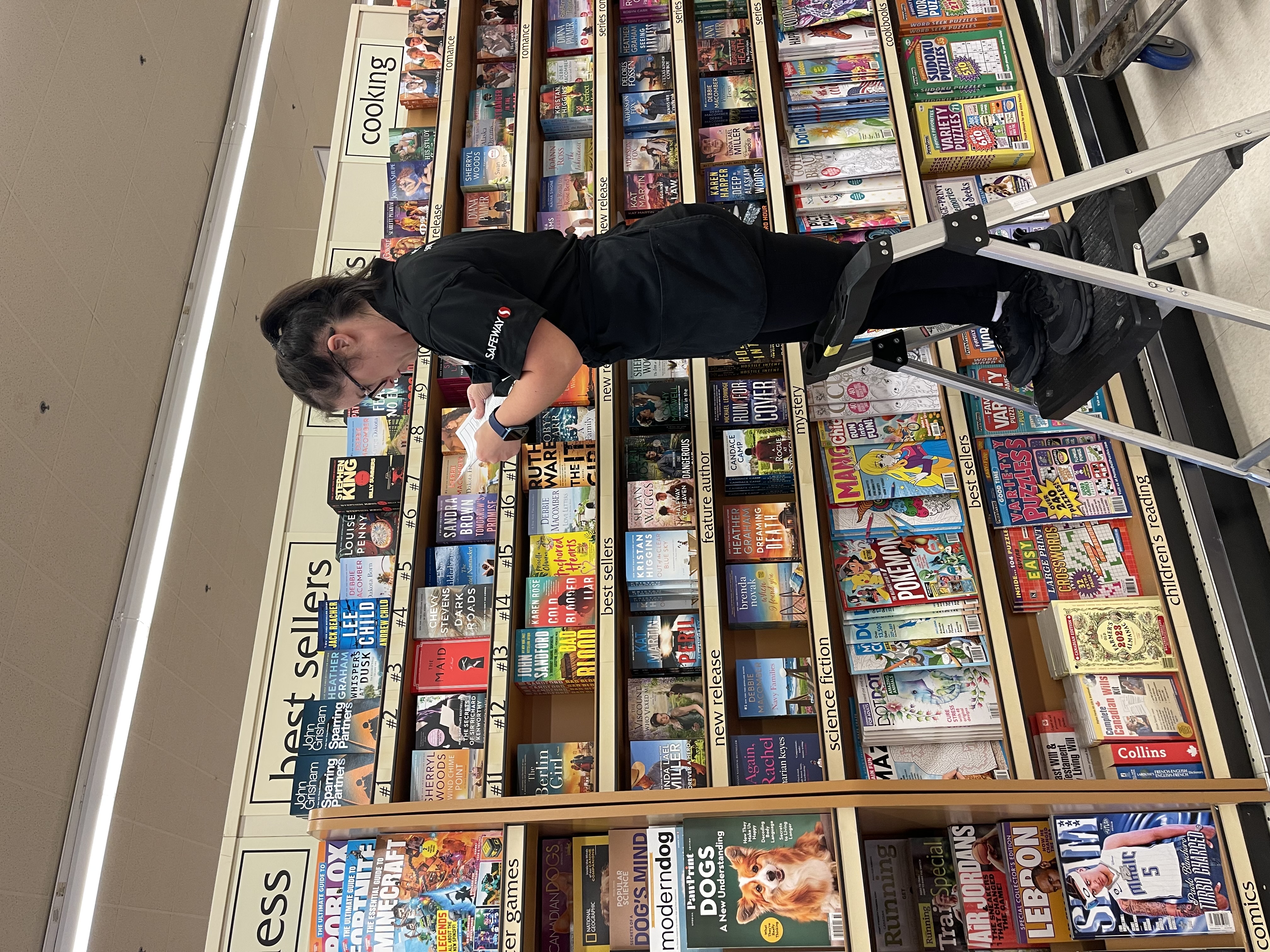Allie Price, Empire Employee and Special Olympics Athlete, stocking book shelves at the Safeway store she works at. 