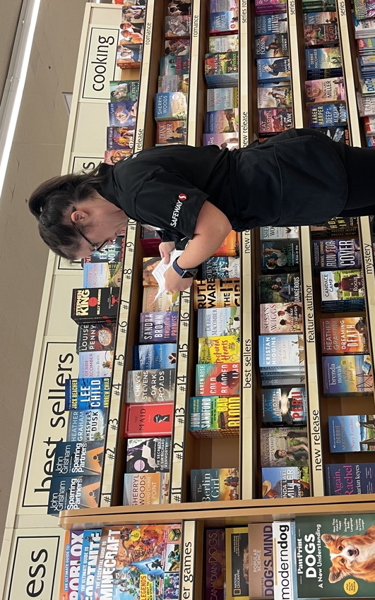 Allie Price, Empire Employee and Special Olympics Athlete, stocking book shelves at the Safeway store she works at. 