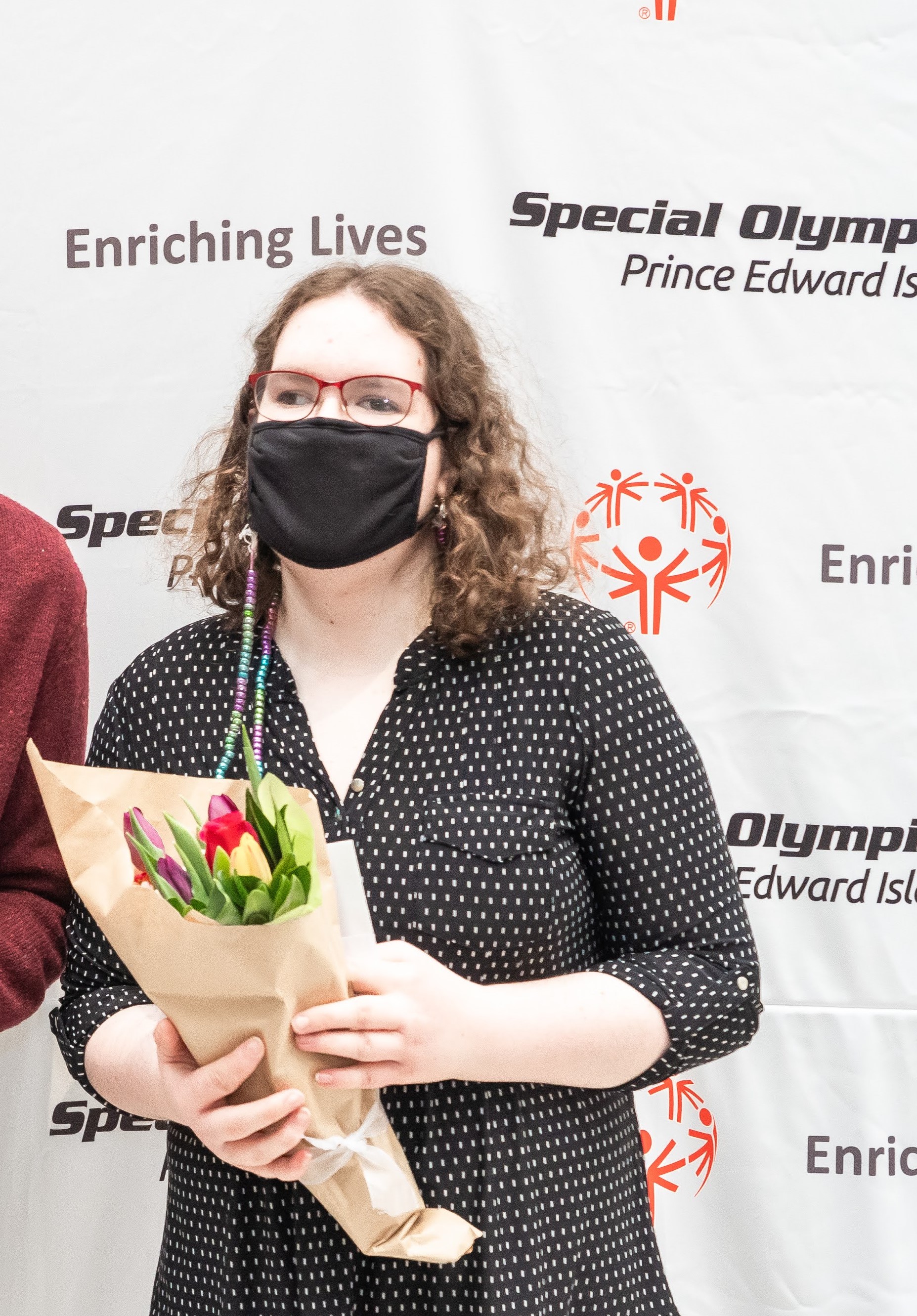 Athlete Leader, Hailliegh Mill, presented with flowers at an event
