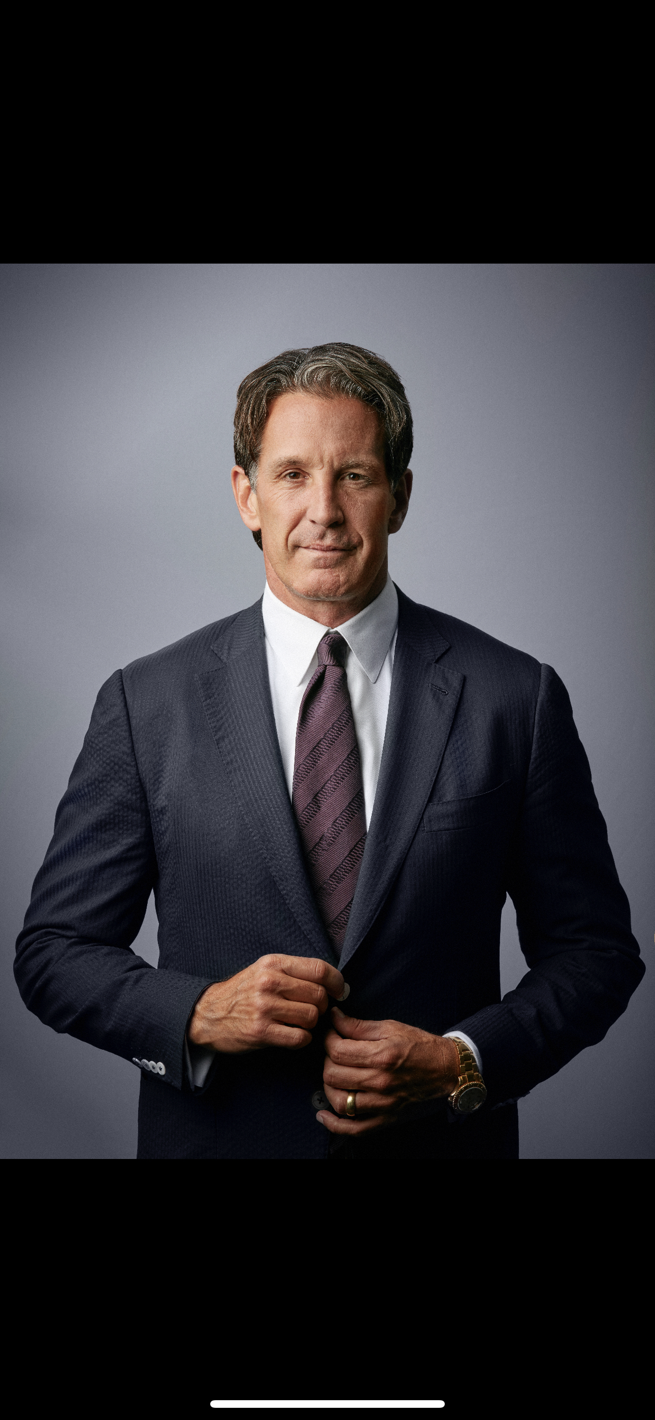 Headshot of a man wearing a suit. Headshot of a man wearing a suit.