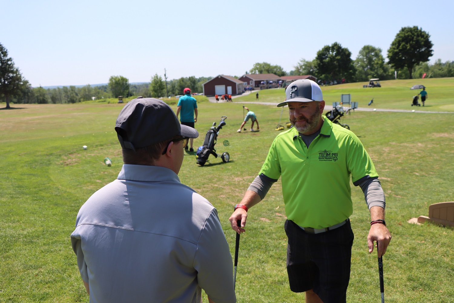 Team PEI 2026 Golf athlete, Colton Matheson, talking with Coach / Caddie on golf course