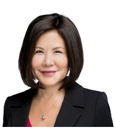 Woman with dark hair wearing a black blazer. 