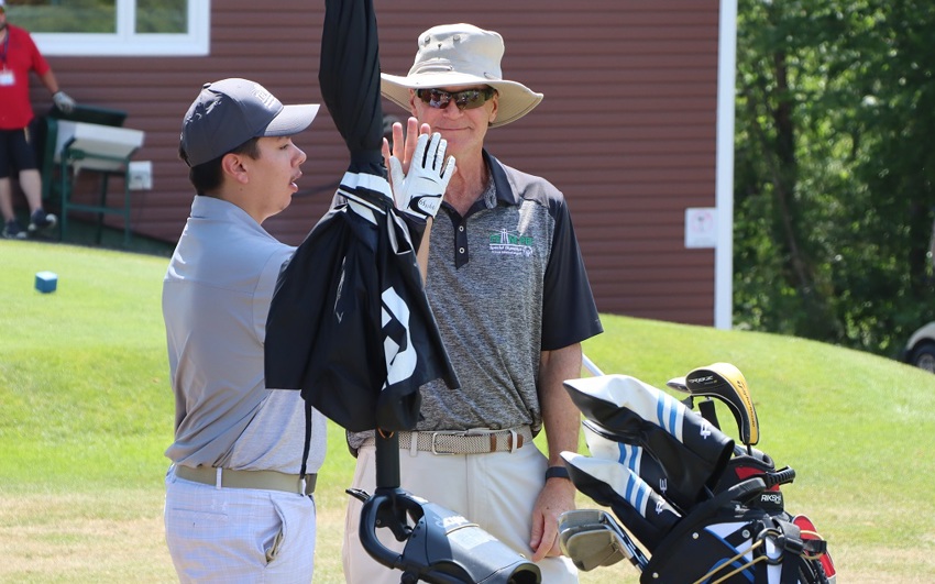 Team PEI 2026 Golf athlete, Matthew Jehn, giving his Coach / Caddie a high five