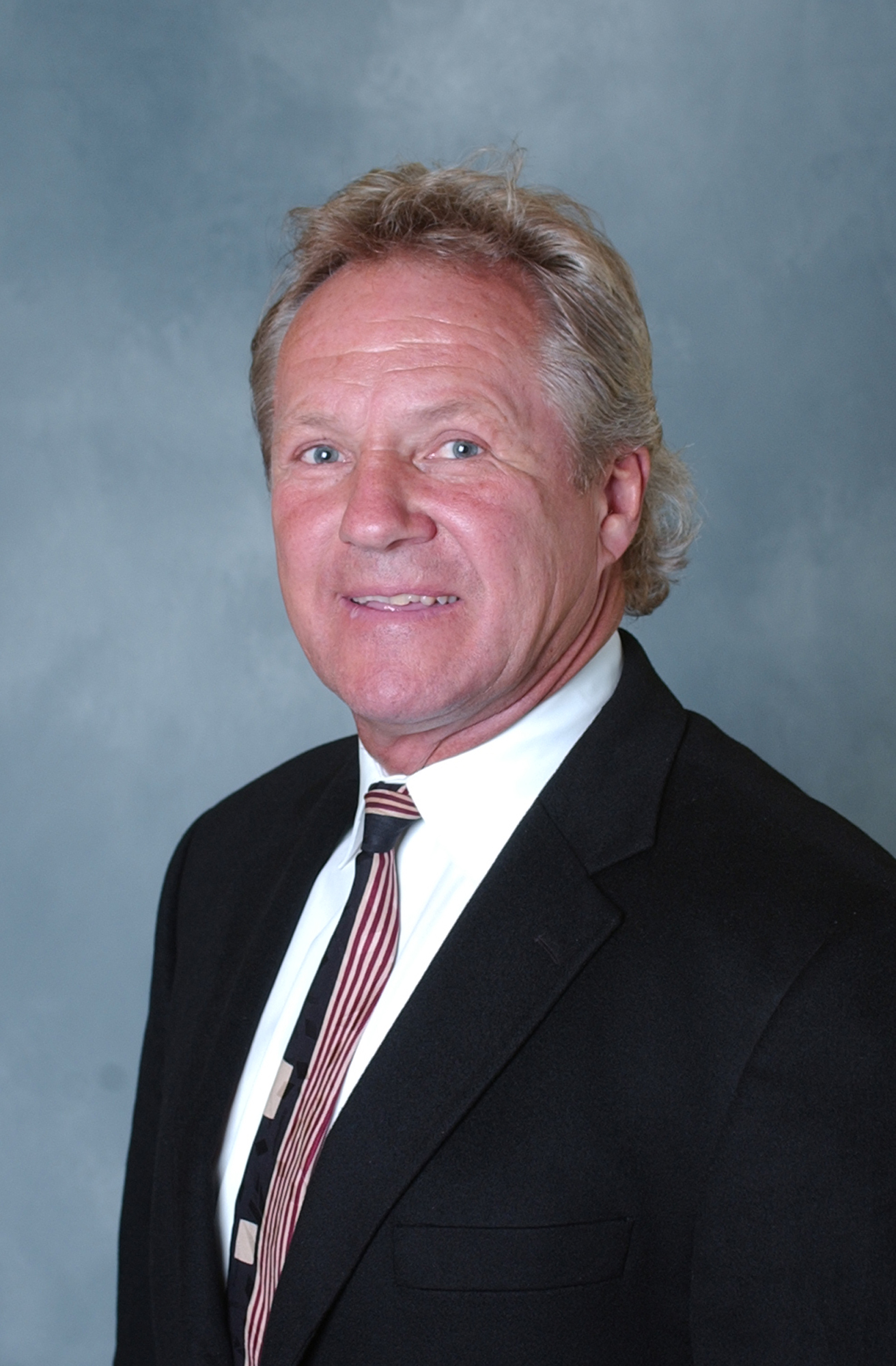 Headshot of a man in a suit. Headshot of a man in a suit.