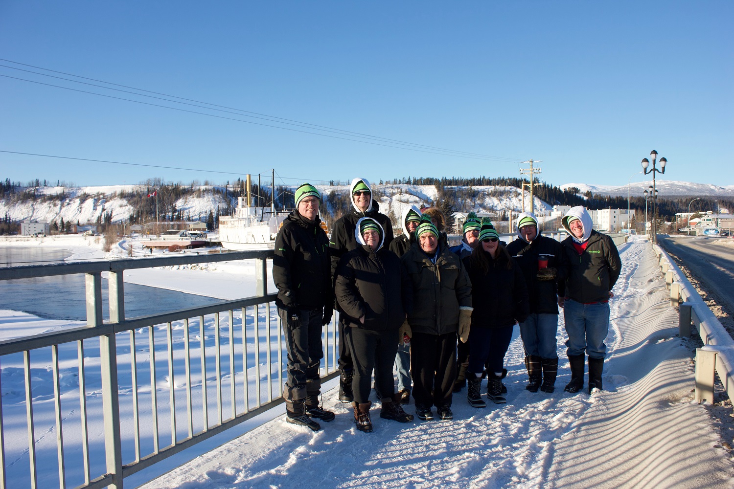 A group of Special Olympics athletes and volunteers standing outside in Yukon in the winter