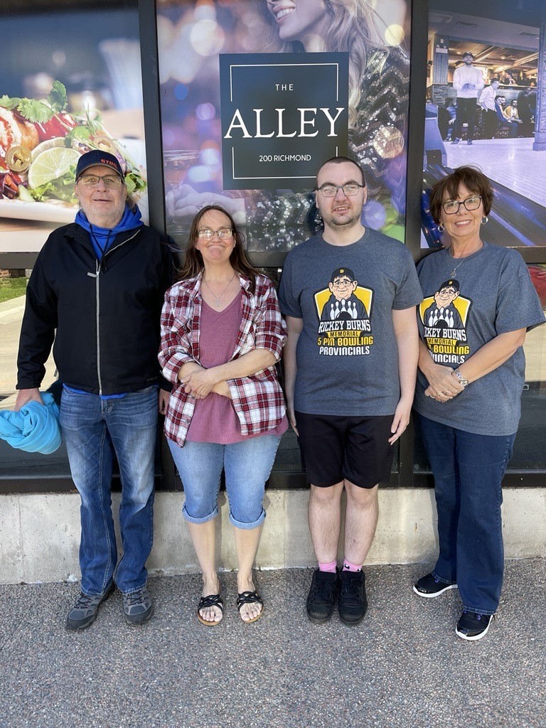 A group of 4 people standing outside