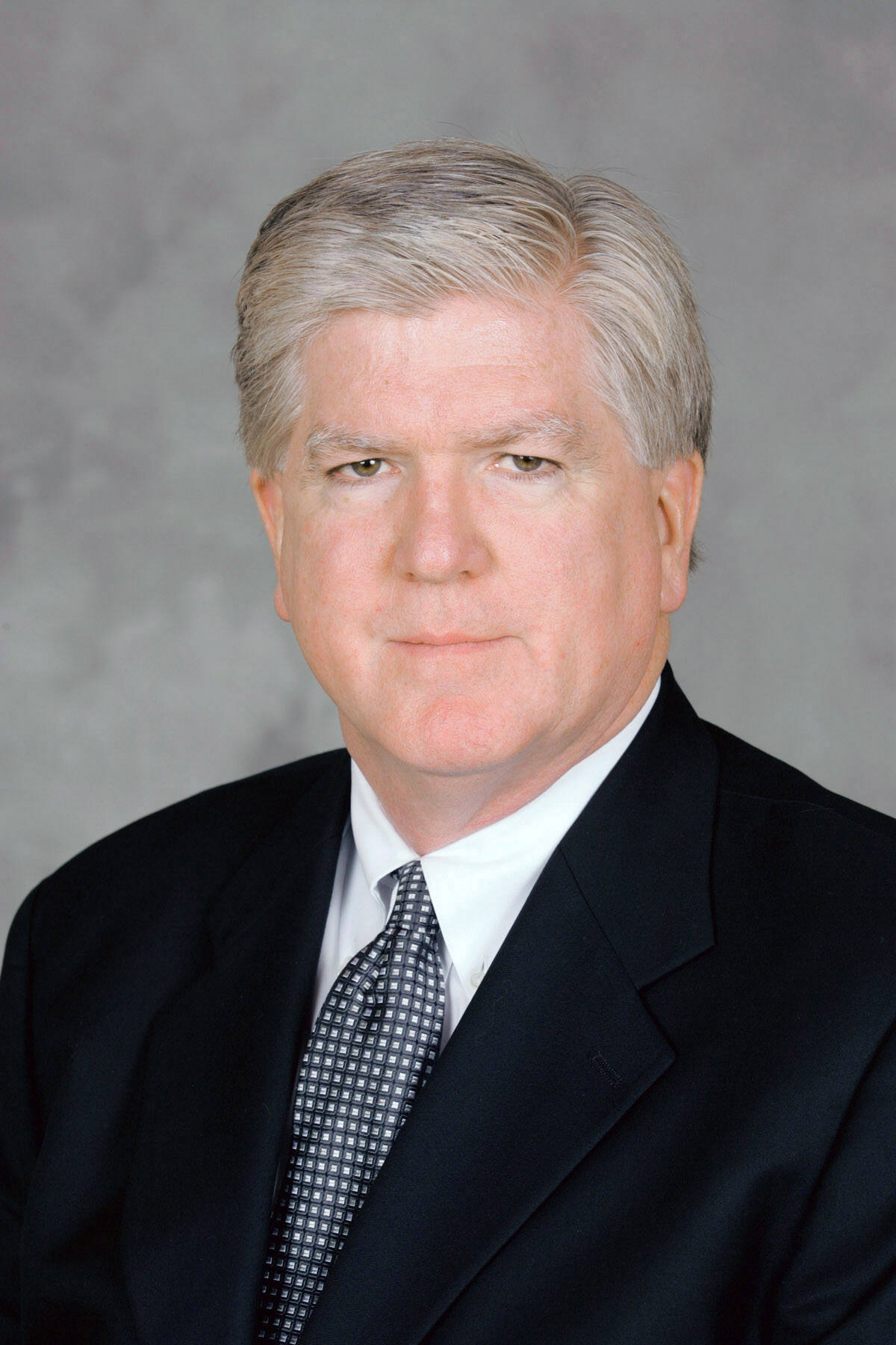 Headshot of a man wearing a suit Headshot of a man wearing a suit