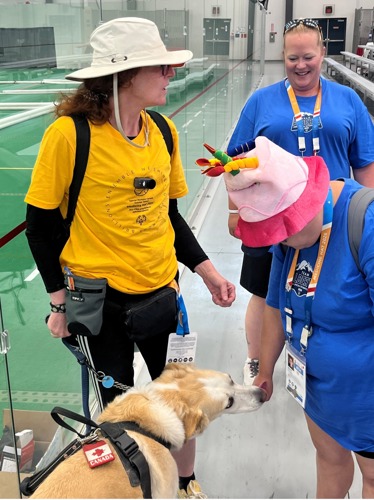 Kelly and her service dog meeting some athletes at the Special Olympics Summer Games Medicine Hat 2026.