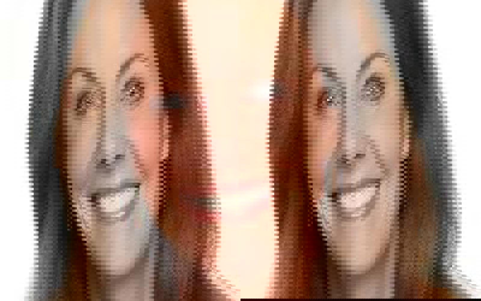 Woman with dark hair smiling at camera. 