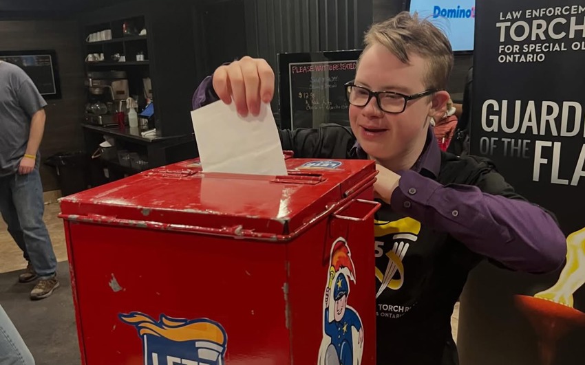 Gage submitting a ballot at the Law Enforcement Torch Run. 