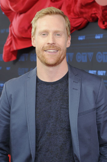 Headshot of a man in black tshirt and grey blazer. Headshot of a man in black tshirt and grey blazer.