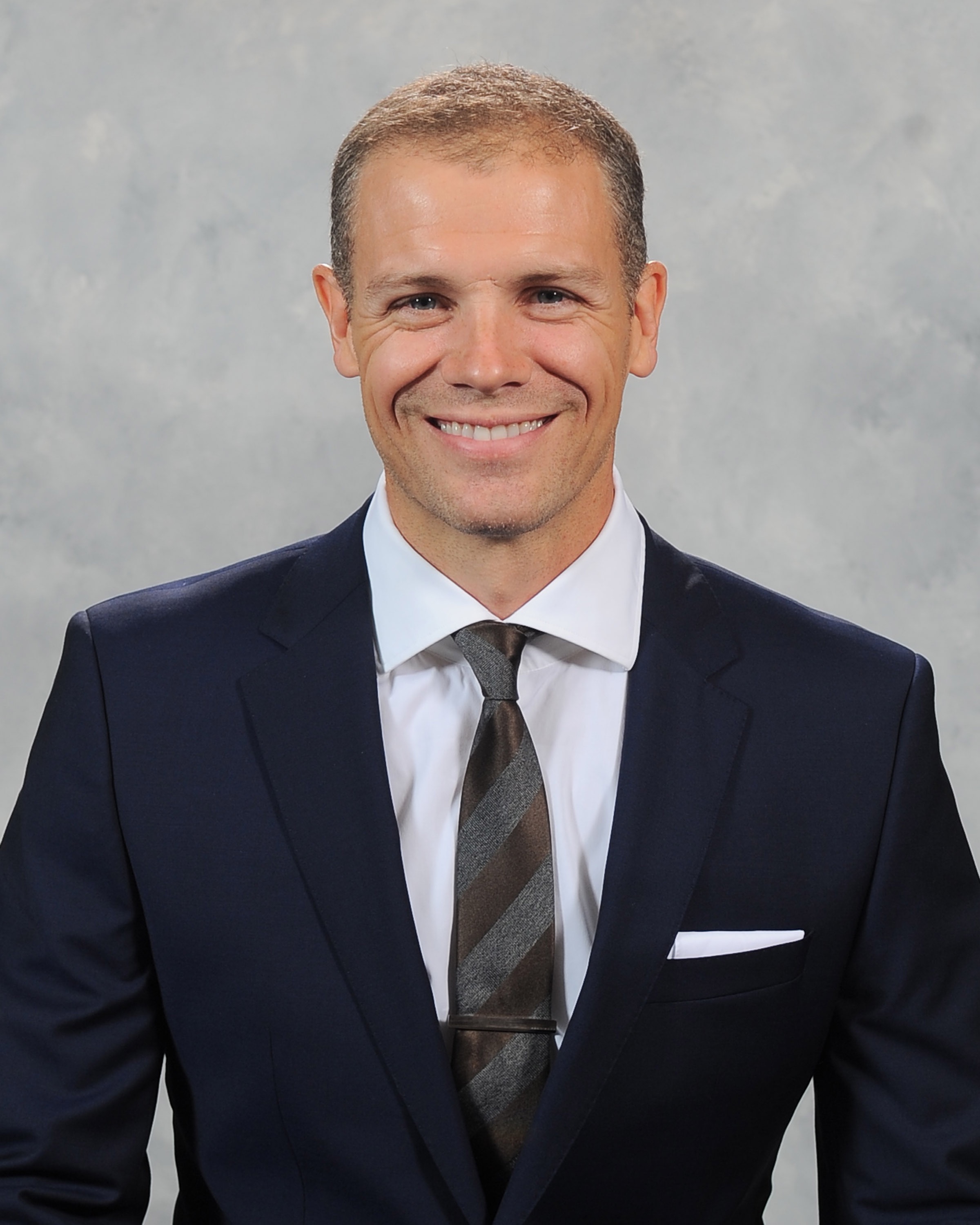 Headshot of a man in a suit. Headshot of a man in a suit.
