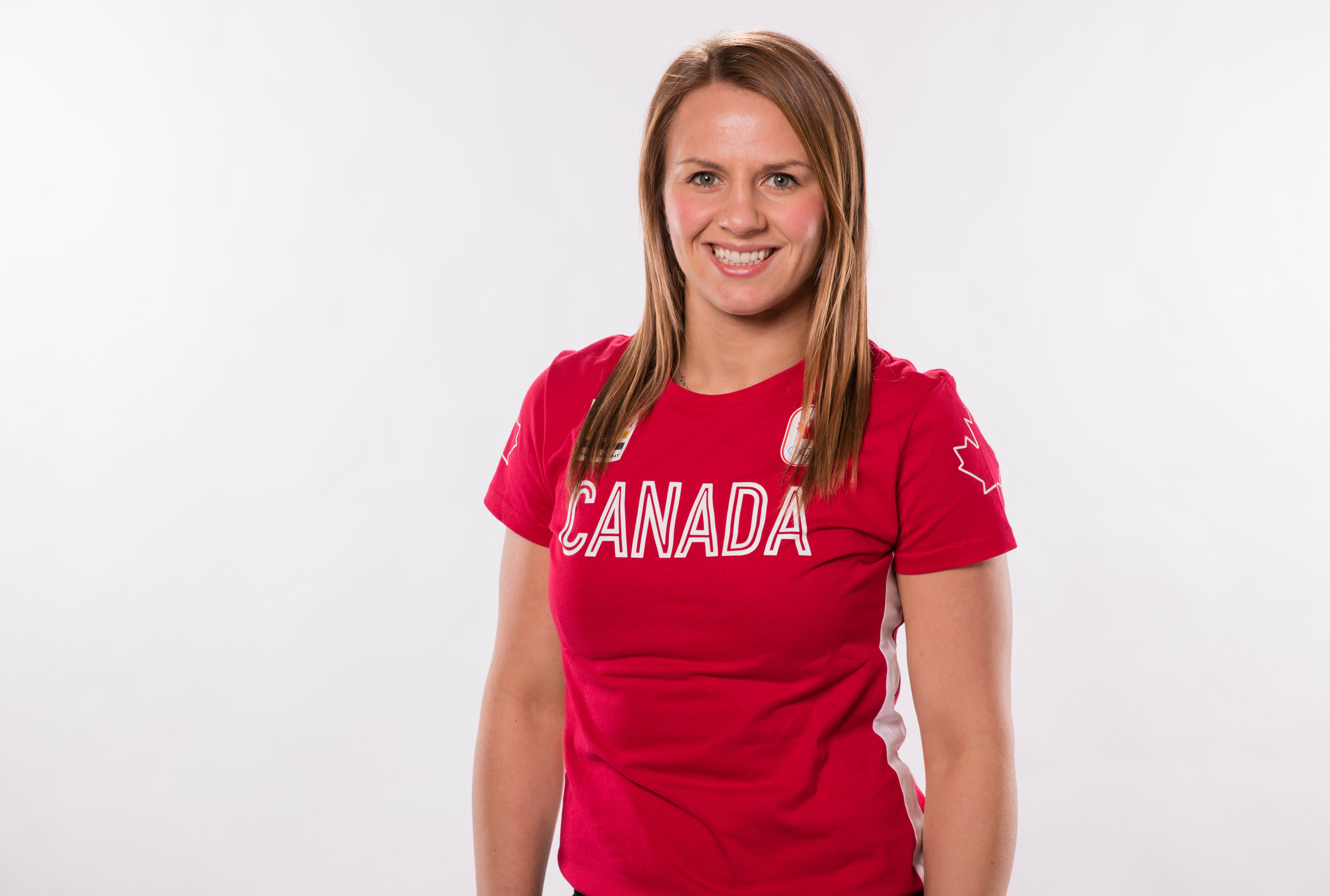 Headshot of a woman with blond hair wearing a red Canada tshirt. Headshot of a woman with blond hair wearing a red Canada tshirt.