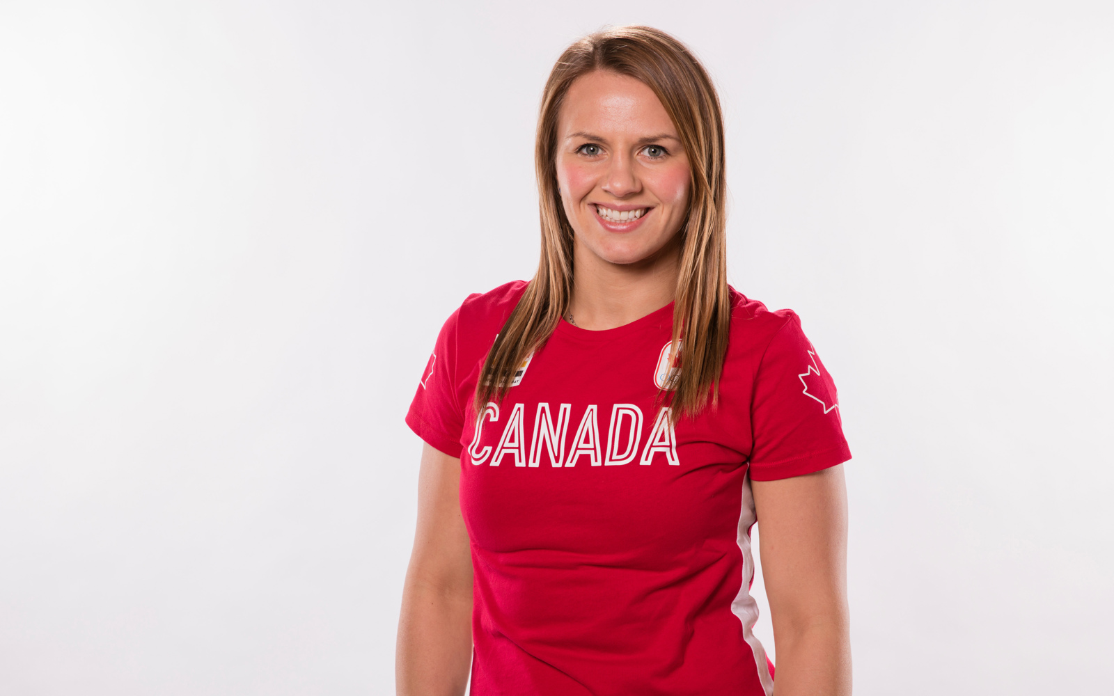 Headshot of a woman with blond hair wearing a red Canada tshirt. 