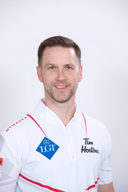 Headshot of a man wearing a jersey with the Tim Hortons logo. Headshot of a man wearing a jersey with the Tim Hortons logo.