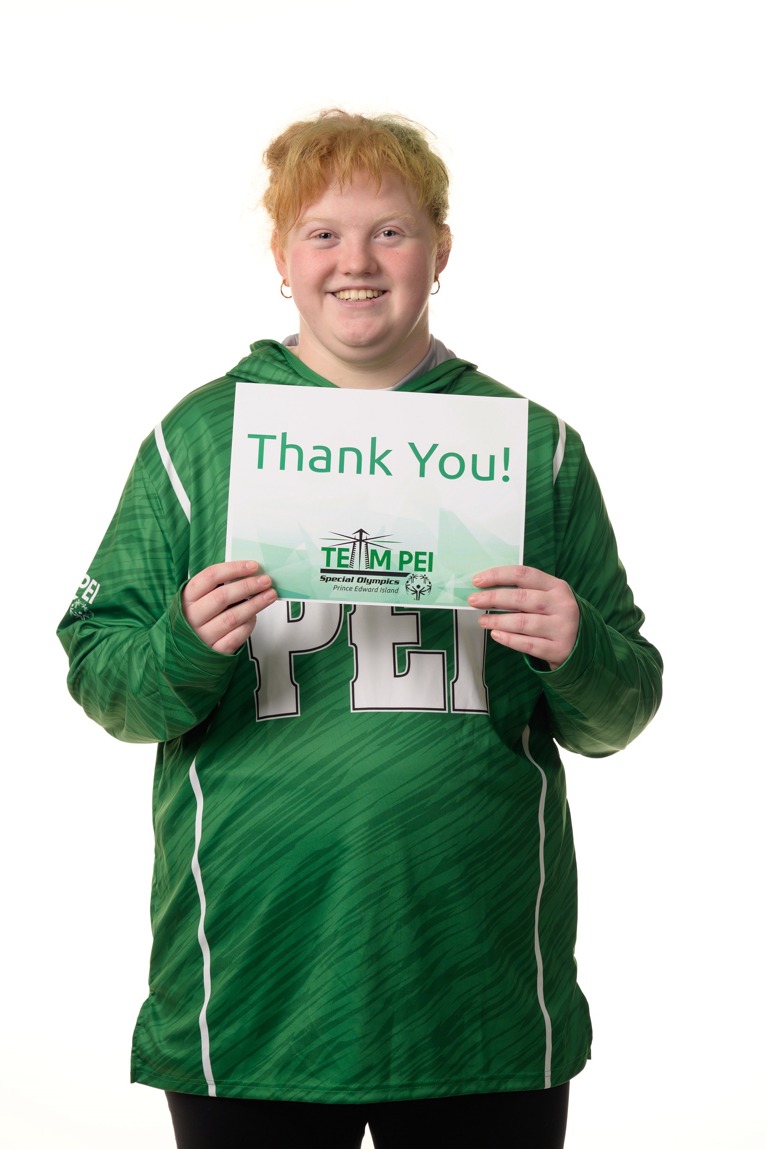Team PEI 2026 Powerlifting athlete, Sophia Allen, standing with a thank you sign 