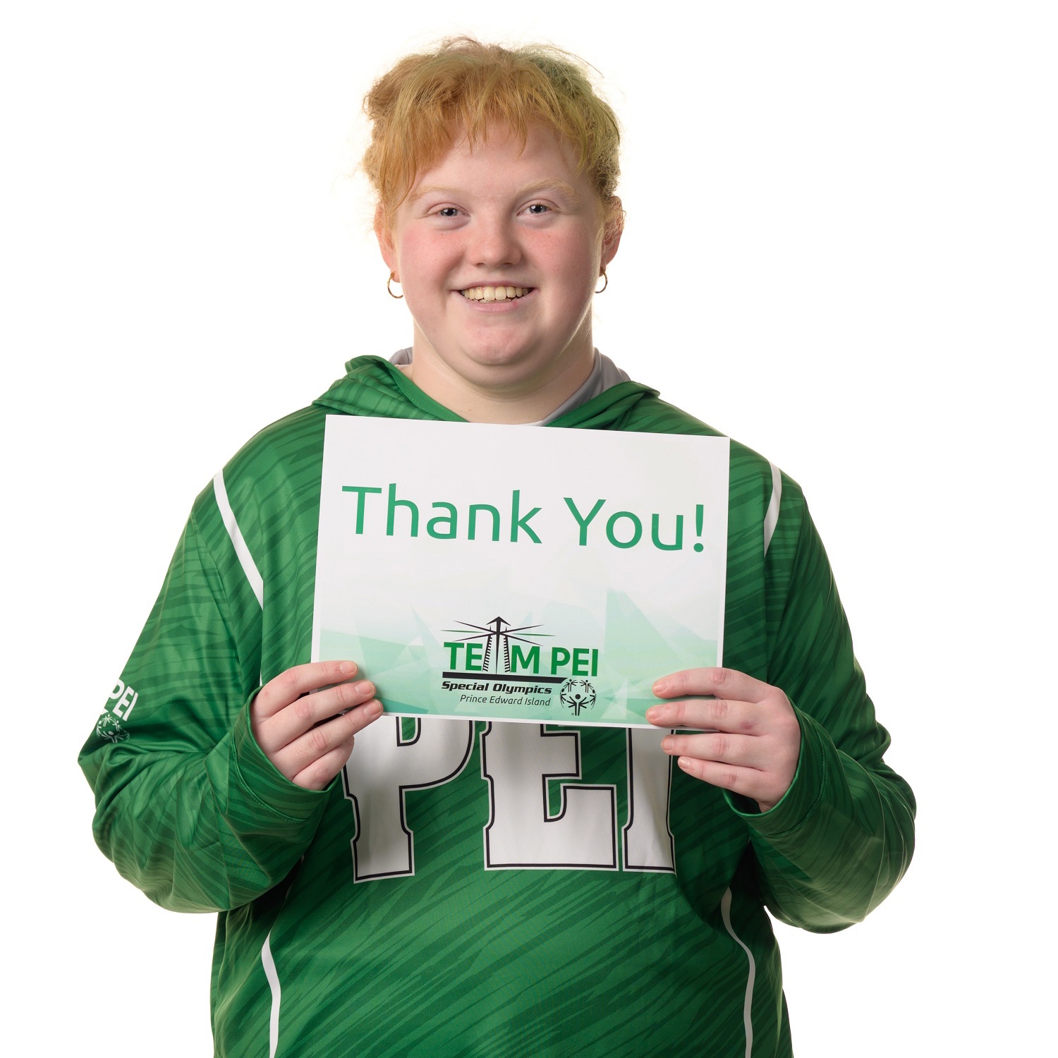Team PEI 2026 Powerlifting athlete, Sophia Allen, standing with a thank you sign 