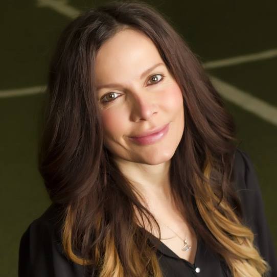 Headshot of a woman with long dark hair. Headshot of a woman with long dark hair.